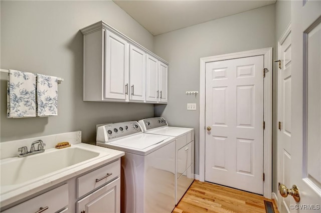 645 Farnham Cir, North Chesterfield, VA 23236 - clothes washing area featuring independent washer and dryer, cabinet space, and light wood-style floors