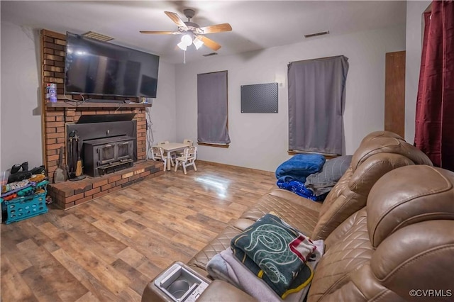 9323 Edington Dr, North Chesterfield, VA 23237 - living area featuring a wood stove, wood finished floors, and ceiling fan