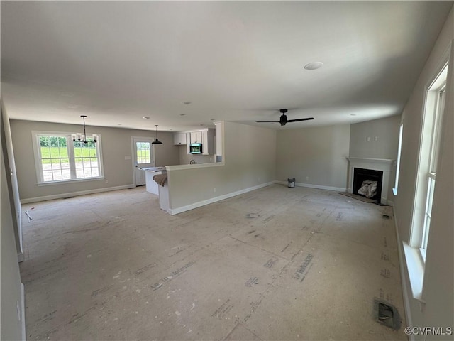 17420 Wedgewood Dr, Lanexa, VA 23089 - unfurnished living room featuring a fireplace, a ceiling fan, a chandelier, and baseboards
