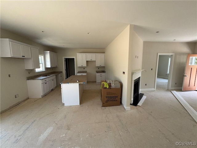 17410 Wedgewood Dr, Lanexa, VA 23089 - kitchen with a center island, white cabinetry, a fireplace with raised hearth, and baseboards