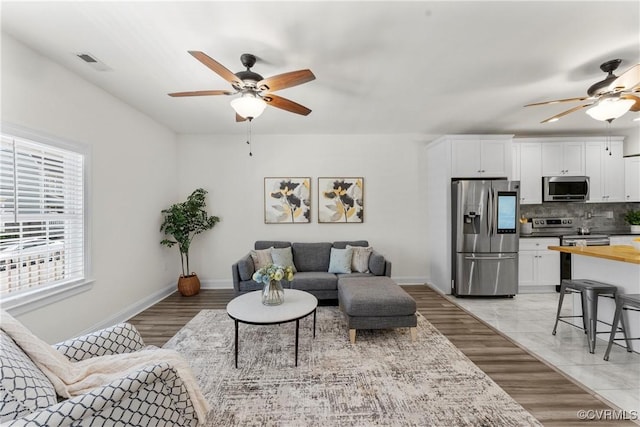 1216 N 30th St, Richmond, VA 23223 - living room with ceiling fan and light wood-style floors