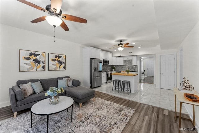 1216 N 30th St, Richmond, VA 23223 - living area featuring a ceiling fan, recessed lighting, and light wood finished floors