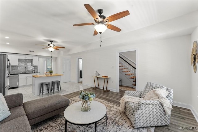 1216 N 30th St, Richmond, VA 23223 - living area with ceiling fan, stairs, recessed lighting, and light wood-type flooring