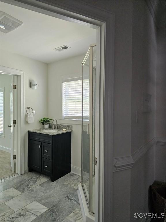1216 N 30th St, Richmond, VA 23223 - bathroom featuring vanity, a stall shower, and marble finish flooring