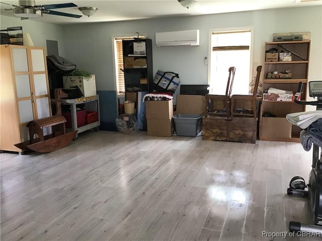 2577 Red Bank Rd, Ark, VA 23061 - living room featuring an AC wall unit, wood finished floors, and ceiling fan