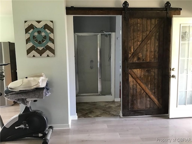 2577 Red Bank Rd, Ark, VA 23061 - bathroom with a shower stall, wood finished floors, and baseboards