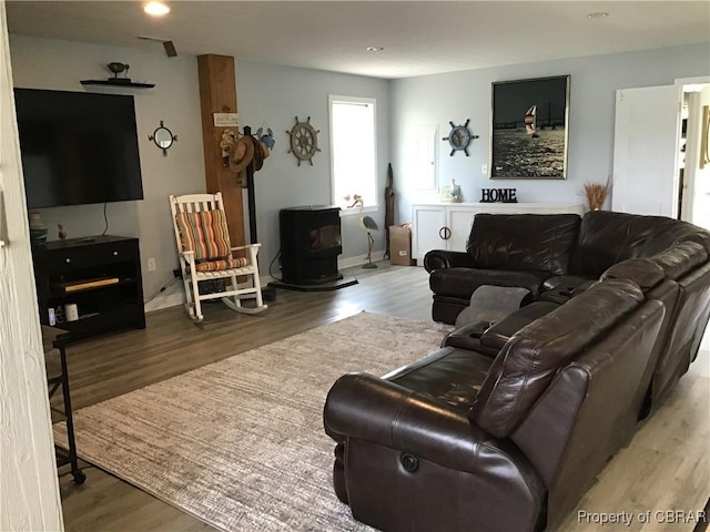 2577 Red Bank Rd, Ark, VA 23061 - living room featuring wood finished floors, a wood stove, and baseboards