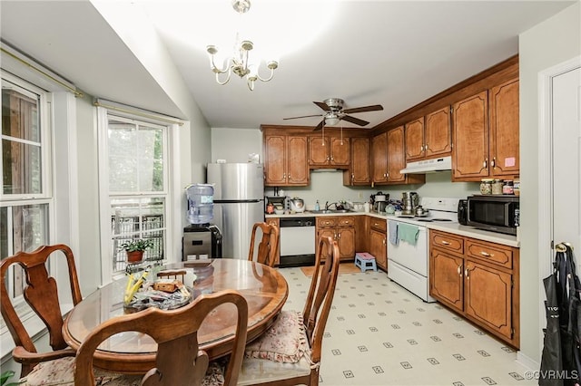2707 Quisenberry St, Midlothian, VA 23112 - kitchen featuring white appliances, under cabinet range hood, brown cabinetry, a sink, and light countertops