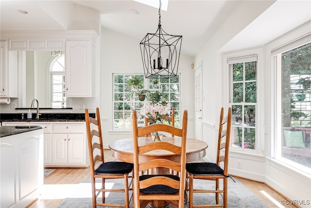 9905 Carrington Pl, Henrico, VA 23238 - dining space featuring a chandelier, light wood finished floors, plenty of natural light, lofted ceiling, and baseboards