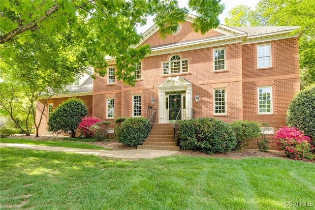 9905 Carrington Pl, Henrico, VA 23238 - georgian-style home with a front lawn and brick siding