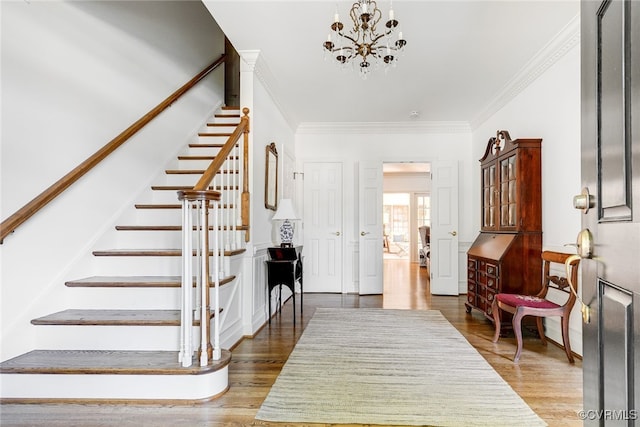 9905 Carrington Pl, Henrico, VA 23238 - entryway with stairs, a chandelier, wood finished floors, and crown molding