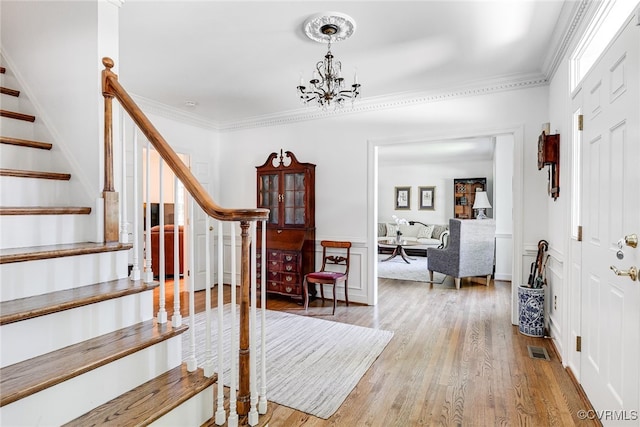9905 Carrington Pl, Henrico, VA 23238 - entrance foyer featuring stairs, light wood-style flooring, a chandelier, and crown molding