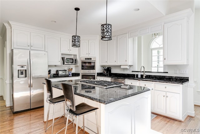 9905 Carrington Pl, Henrico, VA 23238 - kitchen with appliances with stainless steel finishes, a sink, white cabinetry, and light wood-style flooring