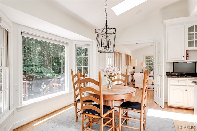 9905 Carrington Pl, Henrico, VA 23238 - dining area featuring lofted ceiling, light wood finished floors, a skylight, and a chandelier