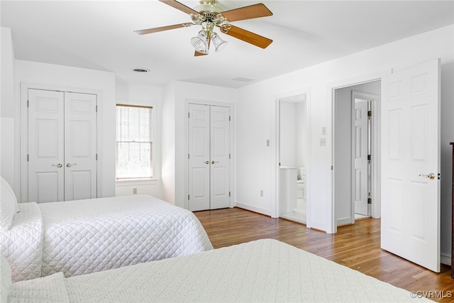 9905 Carrington Pl, Henrico, VA 23238 - bedroom featuring multiple closets, wood finished floors, baseboards, and ceiling fan