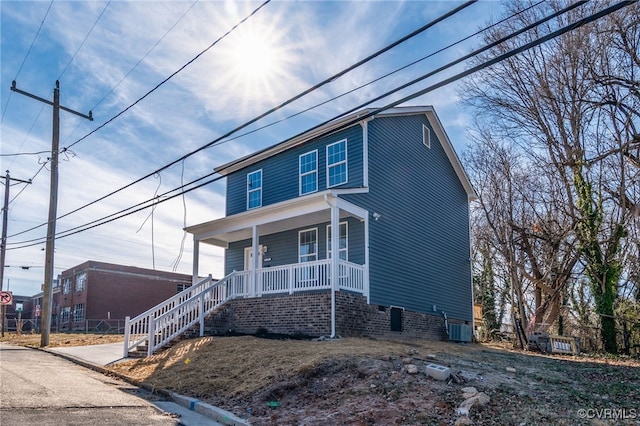 view of front of house featuring a porch and central air condition unit