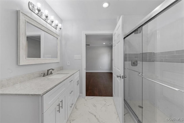 full bath featuring marble finish flooring, recessed lighting, vanity, a shower stall, and baseboards