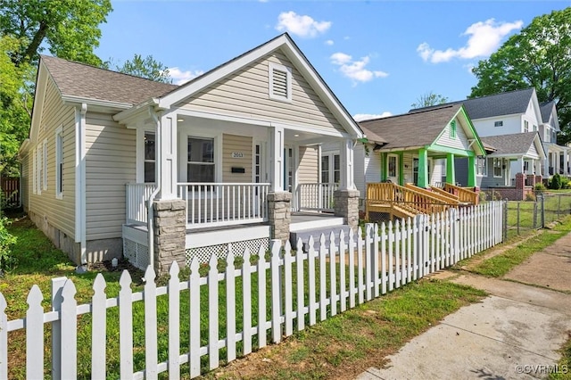view of front of house featuring a porch and a fenced front yard