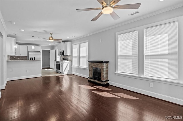 unfurnished living room with a ceiling fan, ornamental molding, baseboards, hardwood / wood-style flooring, and recessed lighting