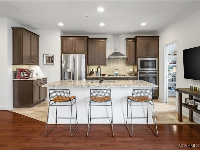 5435 Libbie Mill W Blvd, Henrico, VA 23230 - kitchen featuring wall chimney exhaust hood, stainless steel appliances, a sink, light stone countertops, and dark brown cabinetry
