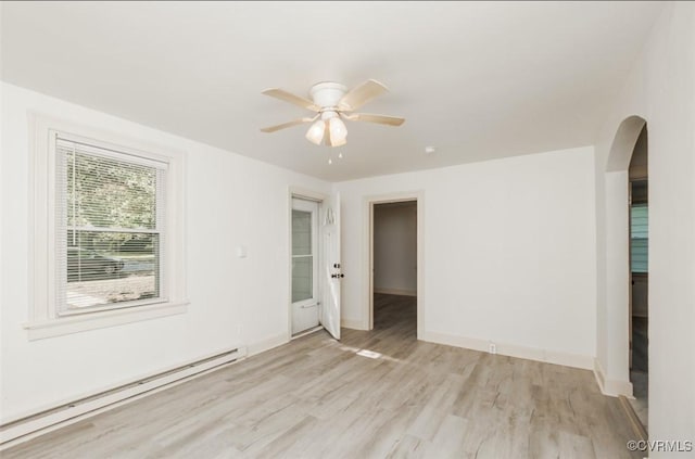 908 Rosemont Rd, Richmond, VA 23224 - spare room with a baseboard heating unit, arched walkways, light wood-style flooring, and a ceiling fan
