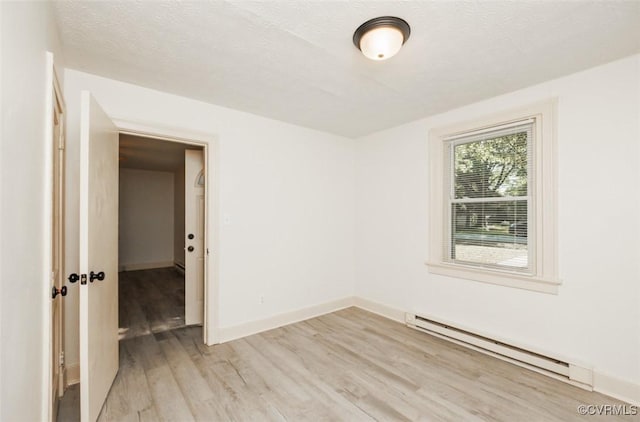 908 Rosemont Rd, Richmond, VA 23224 - spare room featuring baseboard heating and light wood-style floors