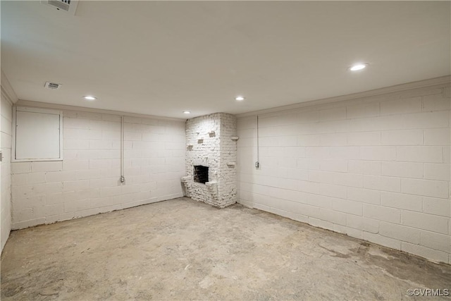 finished below grade area with a fireplace, recessed lighting, and concrete block wall