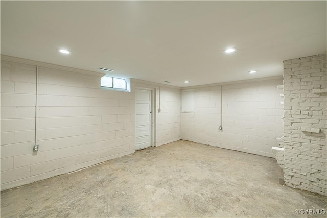 below grade area featuring recessed lighting and concrete block wall