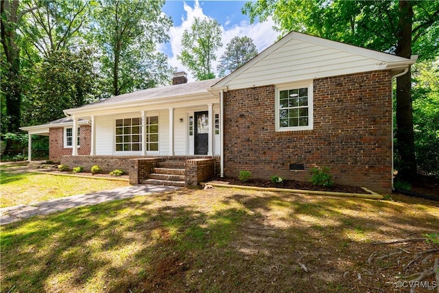 ranch-style house featuring crawl space, a porch, brick siding, and a front yard