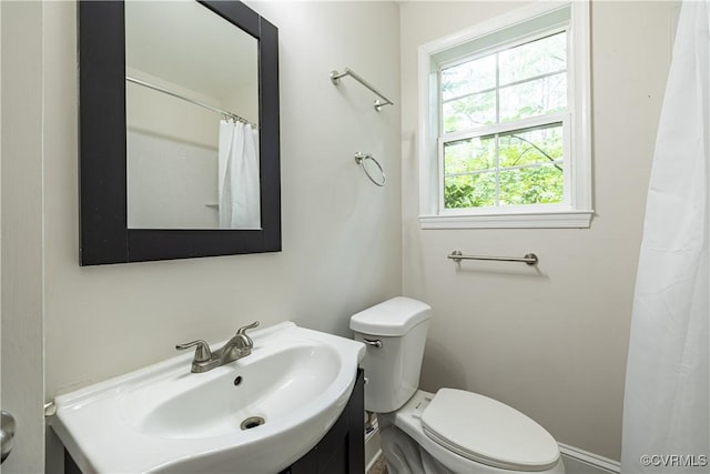 full bathroom with toilet, vanity, and a shower with curtain