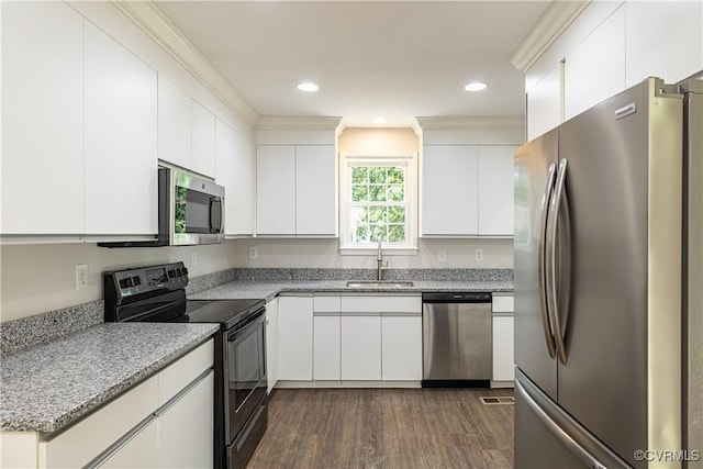 kitchen with stainless steel appliances, a sink, dark wood finished floors, white cabinetry, and light stone counters