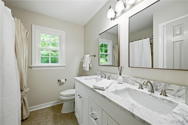 10910 Lesser Scaup Lndg, Chesterfield, VA 23838 - bathroom featuring baseboards, toilet, double vanity, and tile patterned flooring