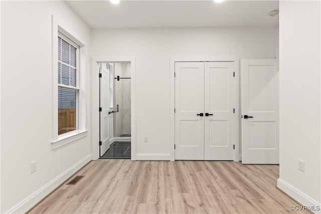 2809 Bethlehem Rd, Henrico, VA 23228 - unfurnished bedroom featuring light wood-style floors, baseboards, ensuite bathroom, and a closet