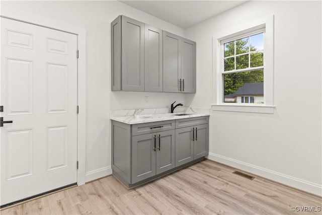 2809 Bethlehem Rd, Henrico, VA 23228 - bar with baseboards, light wood-style flooring, and a sink