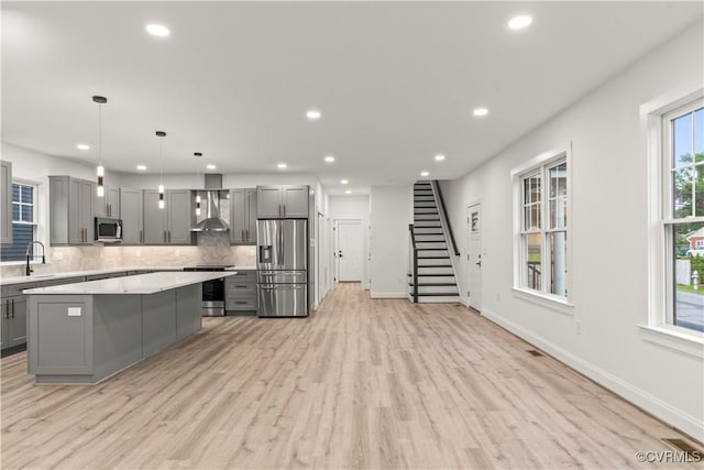 2809 Bethlehem Rd, Henrico, VA 23228 - kitchen with appliances with stainless steel finishes, gray cabinets, wall chimney range hood, light countertops, and recessed lighting