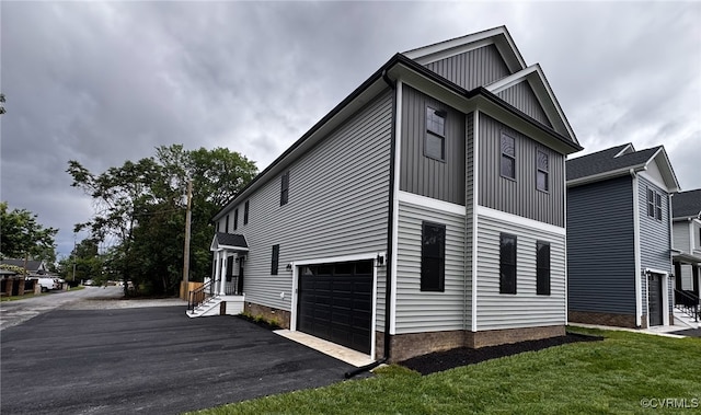 2809 Bethlehem Rd, Henrico, VA 23228 - view of property exterior featuring driveway, a garage, a yard, and board and batten siding