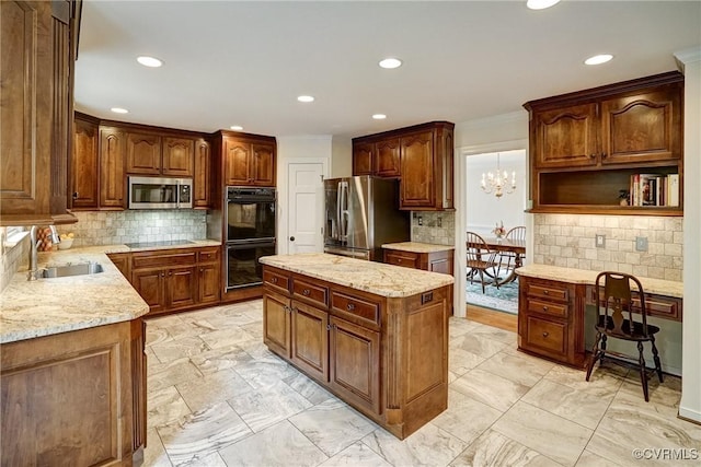kitchen with black appliances, a sink, a kitchen island, decorative backsplash, and recessed lighting