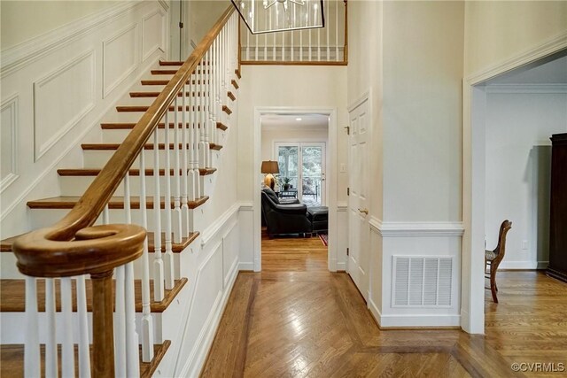 stairs featuring a chandelier and a towering ceiling