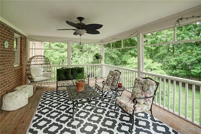 sunroom featuring ceiling fan and an outdoor living space