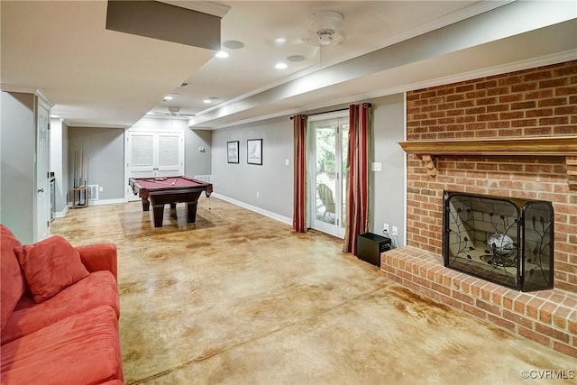 rec room with billiards, a fireplace, baseboards, crown molding, and finished concrete floors
