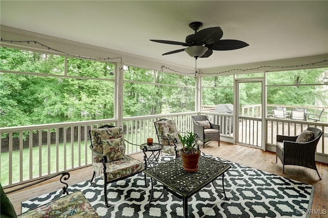 sunroom / solarium with a ceiling fan