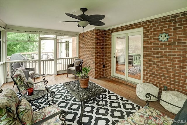 sunroom / solarium with plenty of natural light and ceiling fan