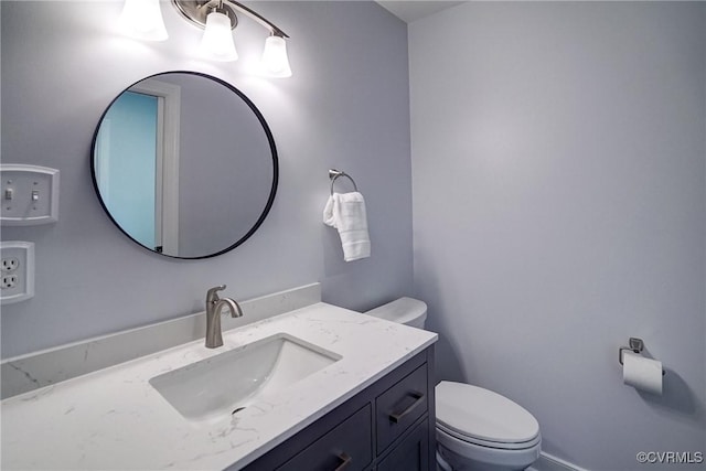 bathroom featuring toilet and vanity