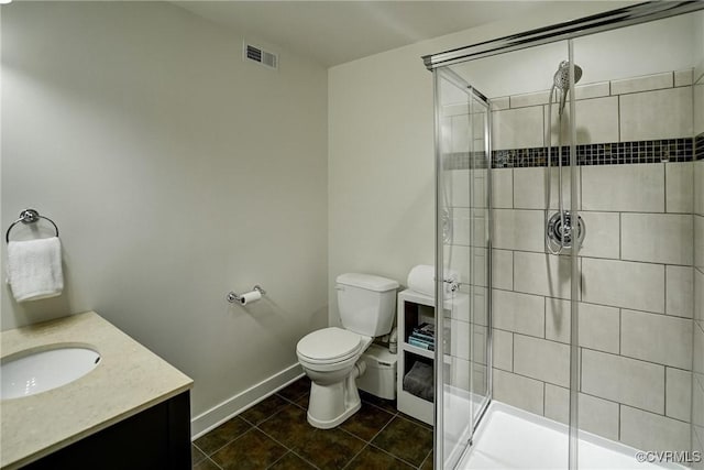 full bathroom featuring a shower stall, toilet, vanity, and tile patterned flooring