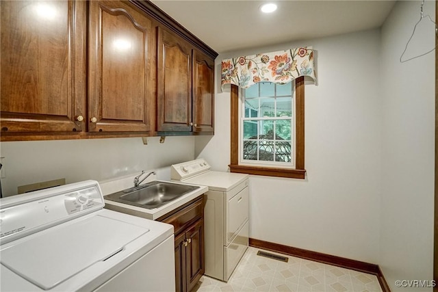 washroom with cabinet space, washing machine and dryer, baseboards, and recessed lighting