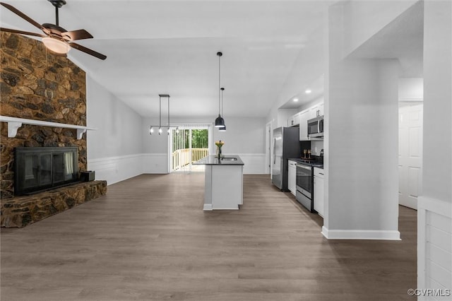 7408 Newbys Ct, Chesterfield, VA 23832 - kitchen featuring vaulted ceiling, dark countertops, appliances with stainless steel finishes, white cabinets, and a ceiling fan