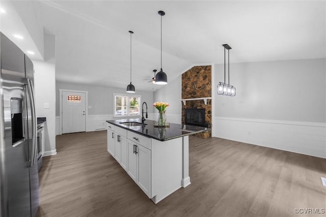 7408 Newbys Ct, Chesterfield, VA 23832 - kitchen with appliances with stainless steel finishes, a stone fireplace, a sink, vaulted ceiling, and dark wood-style flooring