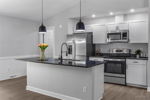 7408 Newbys Ct, Chesterfield, VA 23832 - kitchen featuring stainless steel appliances, a sink, dark wood-style floors, hanging light fixtures, and a kitchen island with sink