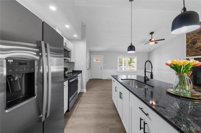 7408 Newbys Ct, Chesterfield, VA 23832 - kitchen featuring appliances with stainless steel finishes, a sink, wood finished floors, pendant lighting, and dark stone countertops