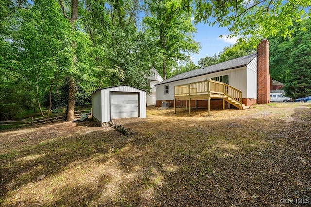 7408 Newbys Ct, Chesterfield, VA 23832 - back of property featuring stairway, a chimney, a wooden deck, an outdoor structure, and a garage